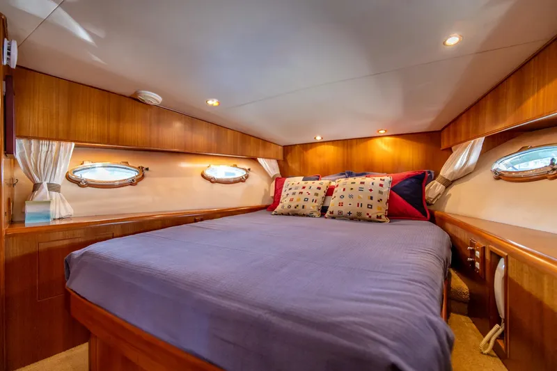Slide: The Image of Luxurious bedroom in a 2003 Ocean Alexander 48 Sedan yacht with cozy bedding. - 17