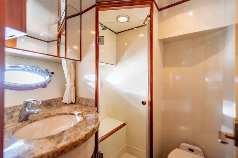 Slide: The Image of Luxurious bathroom in 2003 Ocean Alexander 48 Sedan yacht with granite countertop and shower. - 18