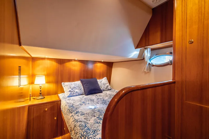 Slide: The Image of Luxurious bedroom interior of 2003 Ocean Alexander 48 Sedan yacht with wooden finishes. - 19