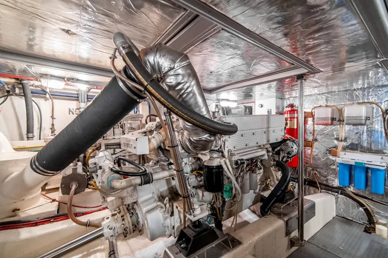 Slide: The Image of Engine room of a 2003 Ocean Alexander 48 Sedan yacht, showcasing mechanical components. - 26