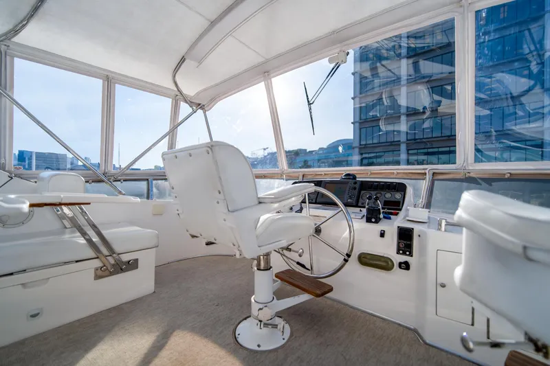 Slide: The Image of 2003 Ocean Alexander 48 Sedan yacht helm station with panoramic windows. - 7