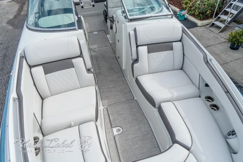 Slide: The Image of 2024 Crownline E305 XS boat interior with luxurious white seating. - 11