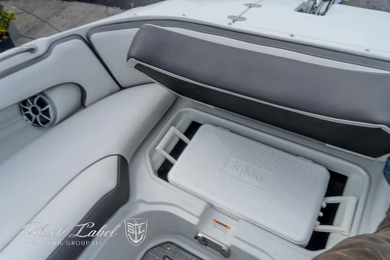Slide: The Image of 2024 Crownline E305 XS boat interior with storage compartment and cooler. - 13