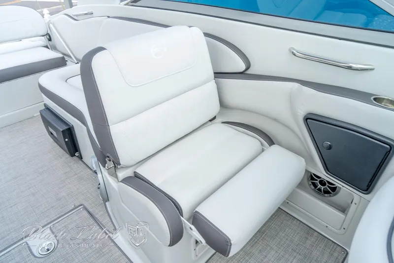 Slide: The Image of 2024 Crownline E305 XS boat interior with plush seating and modern design. - 20