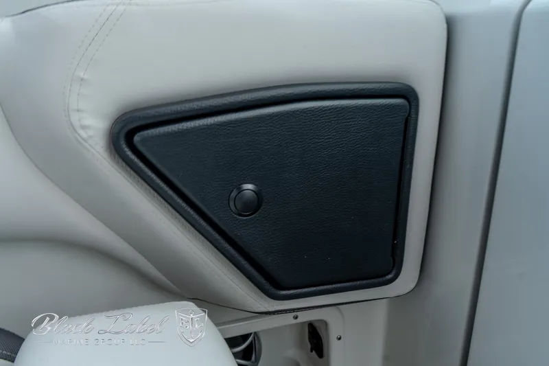 Slide: The Image of 2024 Crownline E305 XS interior detail with black panel on light upholstery. - 21