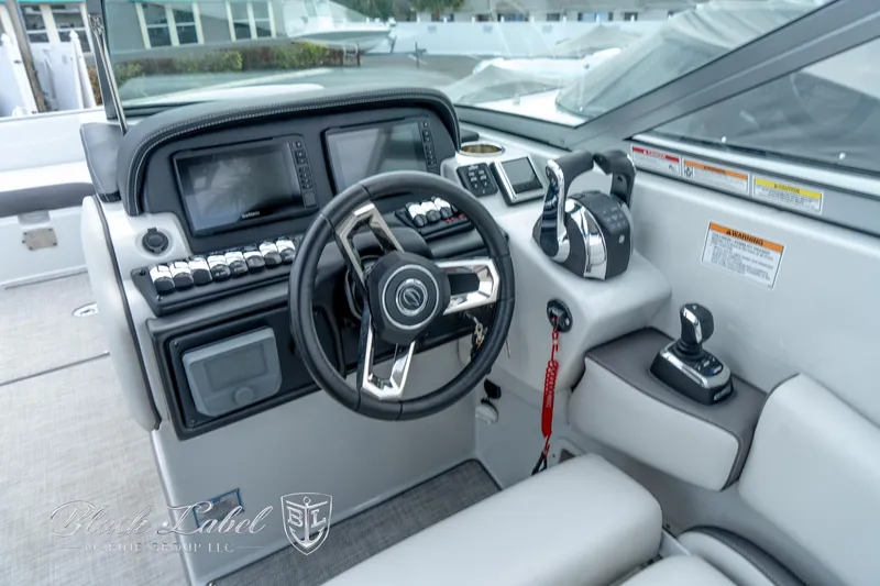 Slide: The Image of 2024 Crownline E305 XS boat cockpit with modern steering and control panel. - 22