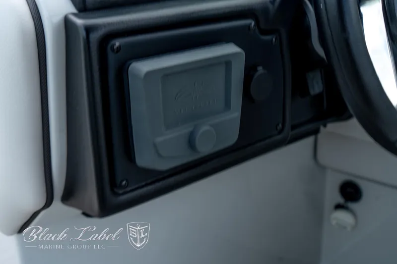 Slide: The Image of 2024 Crownline E305 XS dashboard detail with control panel. - 25