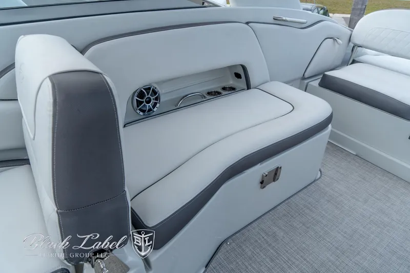 Slide: The Image of 2024 Crownline E305 XS boat interior with gray seating and speaker detail. - 29