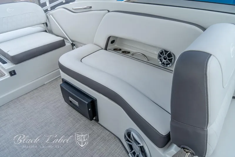 Slide: The Image of 2024 Crownline E305 XS boat interior with gray seating and speaker system. - 30