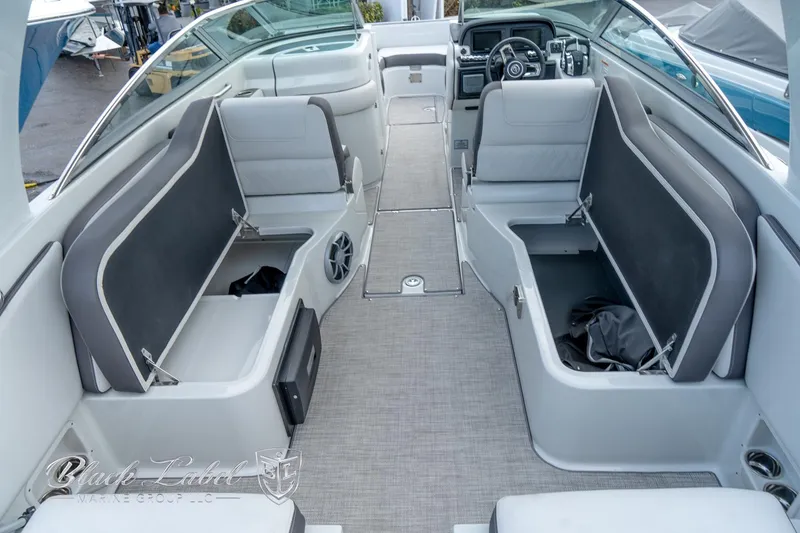 Slide: The Image of 2024 Crownline E305 XS boat interior with spacious seating and storage compartments. - 32