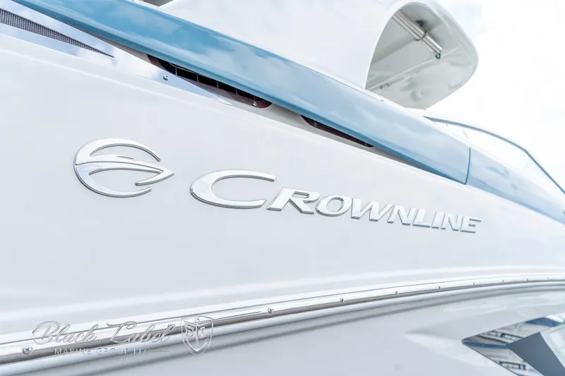 Slide: The Image of 2024 Crownline E305 XS boat, close-up of logo and sleek design. - 4