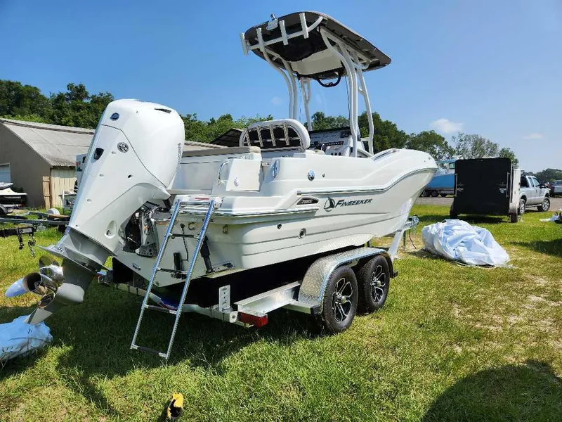 Slide: The Image of 2024 Finseeker 210 FinSeeker boat on trailer, rear view, outdoor setting. - 11