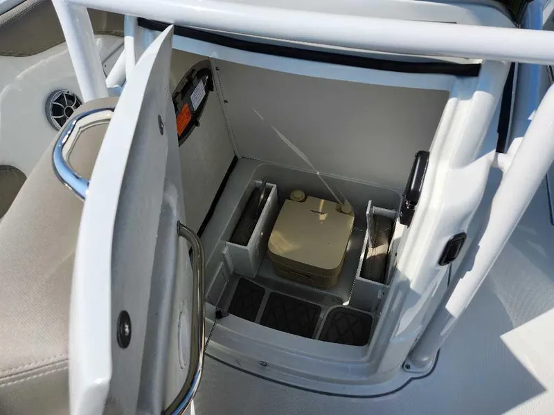 Slide: The Image of 2024 Finseeker 210 FinSeeker boat storage compartment with portable toilet. - 13