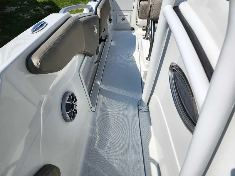 Slide: The Image of 2024 Finseeker 210 FinSeeker boat interior with cushioned seating and built-in speakers. - 3