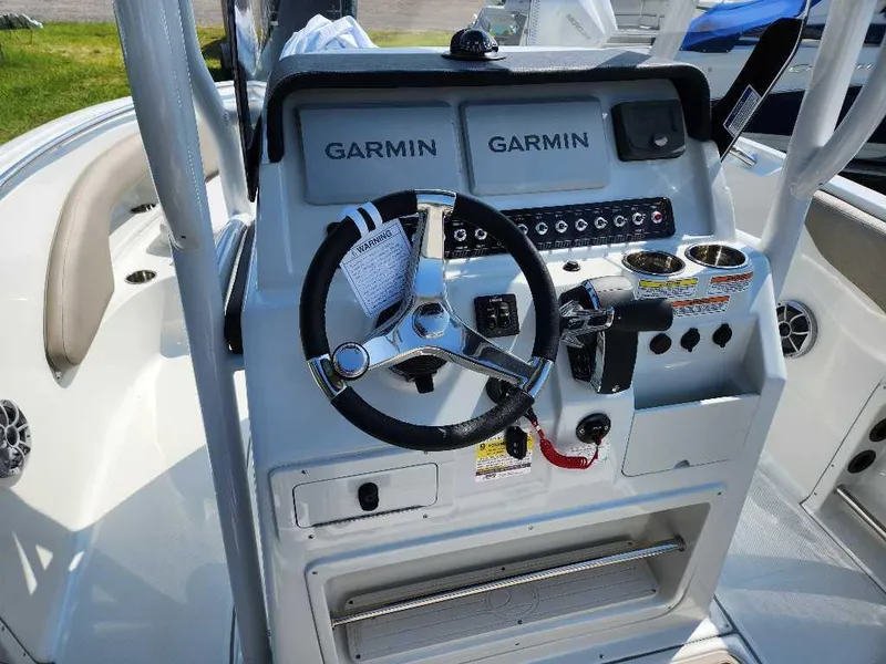 Slide: The Image of 2024 Finseeker 210 FinSeeker boat dashboard with Garmin navigation system and steering wheel. - 4