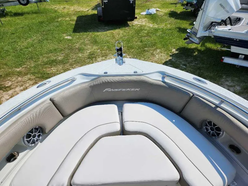 Slide: The Image of 2024 Finseeker 210 FinSeeker boat with cushioned seating and speakers on deck. - 6