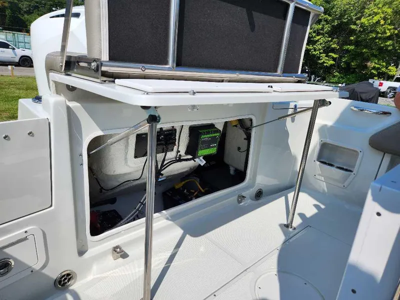 Slide: The Image of 2024 Finseeker 210 FinSeeker boat storage compartment with open hatch and visible wiring. - 9