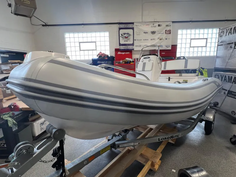 Slide: The Image of 2024 AB Inflatables 15 OCEANUS VST boat on trailer in showroom. - 1