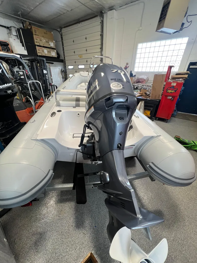 Slide: The Image of 2024 AB Inflatables 15 OCEANUS VST with outboard motor in a garage. - 7