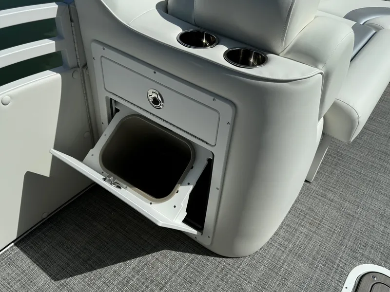 Slide: The Image of 2024 JC Neptoon Sport 23TT DSL boat interior with storage compartment and cup holders. - 12