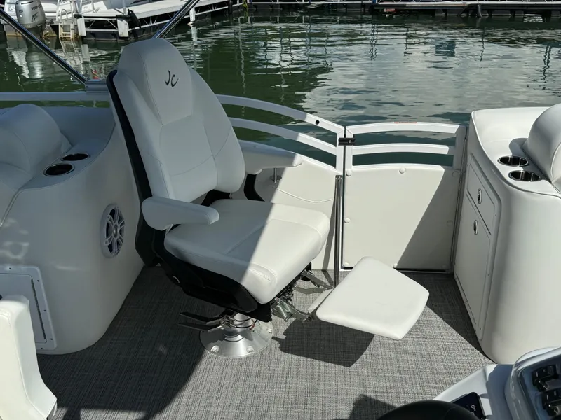 Slide: The Image of 2024 JC Neptoon Sport 23TT DSL boat with white captain's chair and lake view. - 15