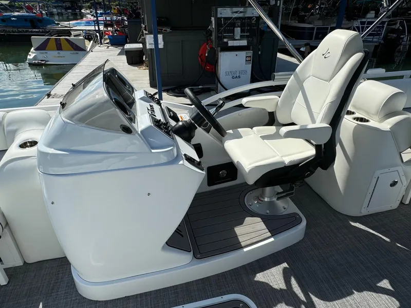 Slide: The Image of 2024 JC Neptoon Sport 23TT DSL boat helm with modern controls and comfortable seating. - 16