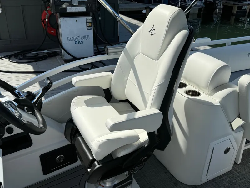 Slide: The Image of Captain's chair on 2024 JC Neptoon Sport 23TT DSL boat, near dockside gas station. - 18