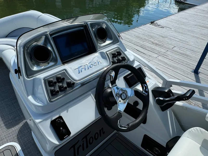 Slide: The Image of 2024 JC Neptoon Sport 23TT DSL boat dashboard with steering wheel and controls. - 19