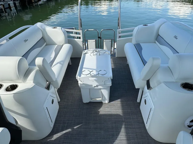 Slide: The Image of 2024 JC Neptoon Sport 23TT DSL pontoon boat interior with plush seating and table. - 22