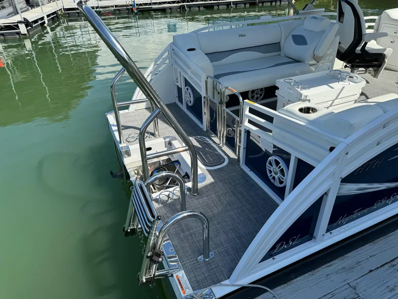 Slide: The Image of 2024 JC Neptoon Sport 23TT DSL pontoon boat with seating and swim ladder at dock. - 24