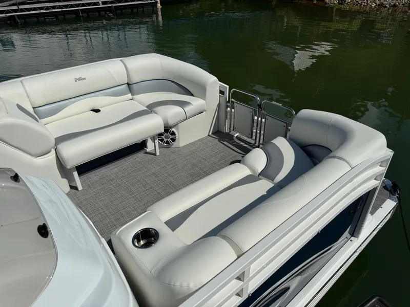 Slide: The Image of 2024 JC Neptoon Sport 23TT DSL pontoon boat with spacious seating on calm water. - 5