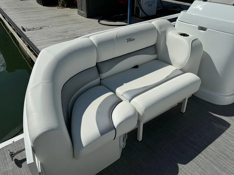 Slide: The Image of 2024 JC Neptoon Sport 23TT DSL boat with plush seating on a dock. - 7