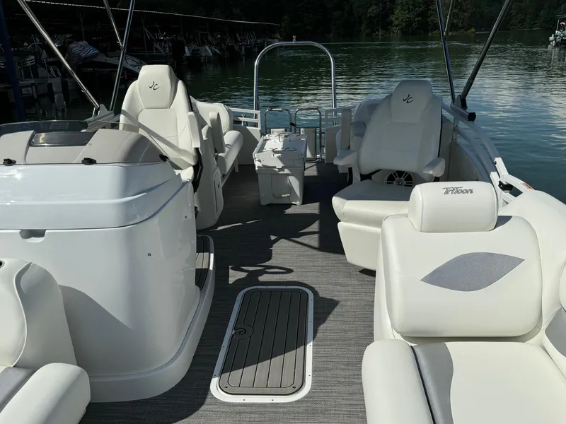 Slide: The Image of 2024 JC Neptoon Sport 23TT DSL pontoon boat interior with white seating and lake view. - 8