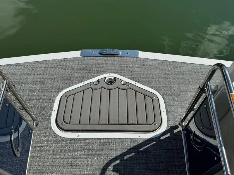 Slide: The Image of 2024 JC Neptoon Sport 23TT DSL boat deck with gray flooring and water view. - 9
