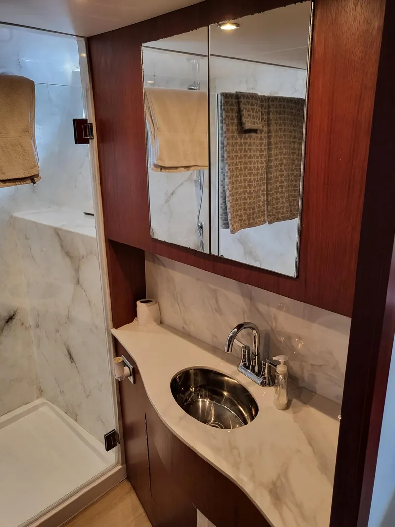 Slide: The Image of Luxurious bathroom in 2005 Pacific Mariner 65 SE Motoryacht with marble and wood finishes. - 18