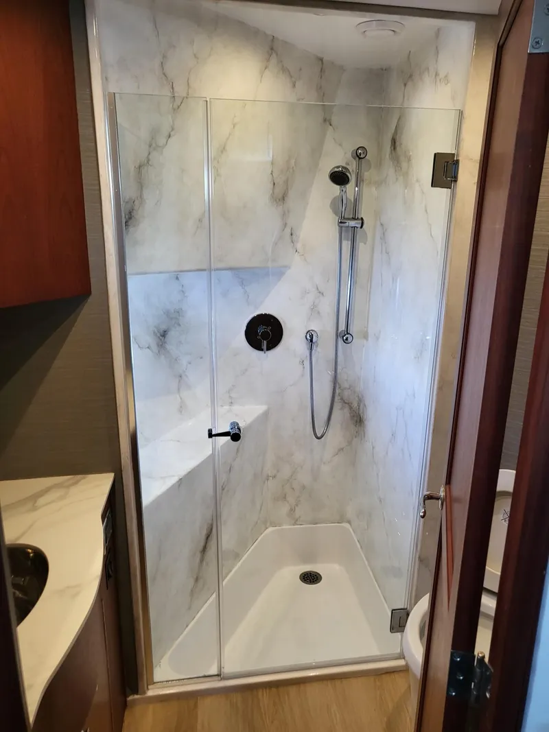 Slide: The Image of Luxurious bathroom shower in 2005 Pacific Mariner 65 SE Motoryacht with marble walls. - 20