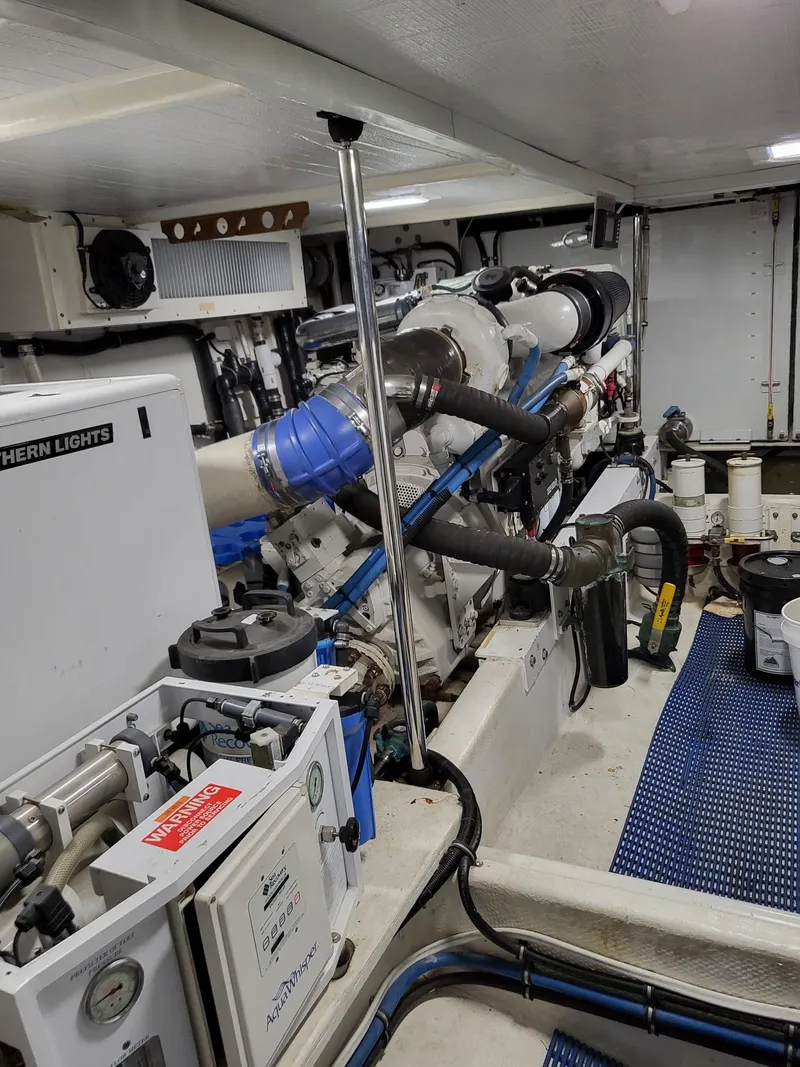 Slide: The Image of Engine room of a 2005 Pacific Mariner 65 SE Motoryacht, showcasing mechanical components and equipment. - 24