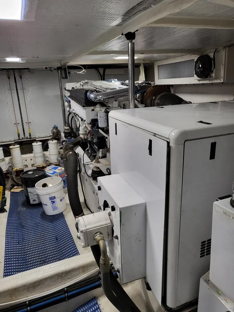 Slide: The Image of Engine room of a 2005 Pacific Mariner 65 SE Motoryacht, featuring mechanical equipment. - 25
