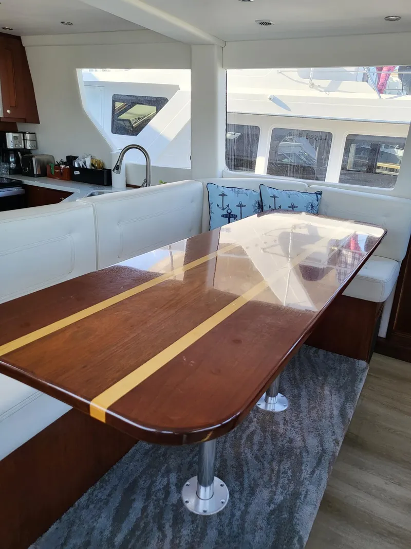 Slide: The Image of Interior of 2005 Pacific Mariner 65 SE Motoryacht with elegant dining area and modern kitchen. - 8