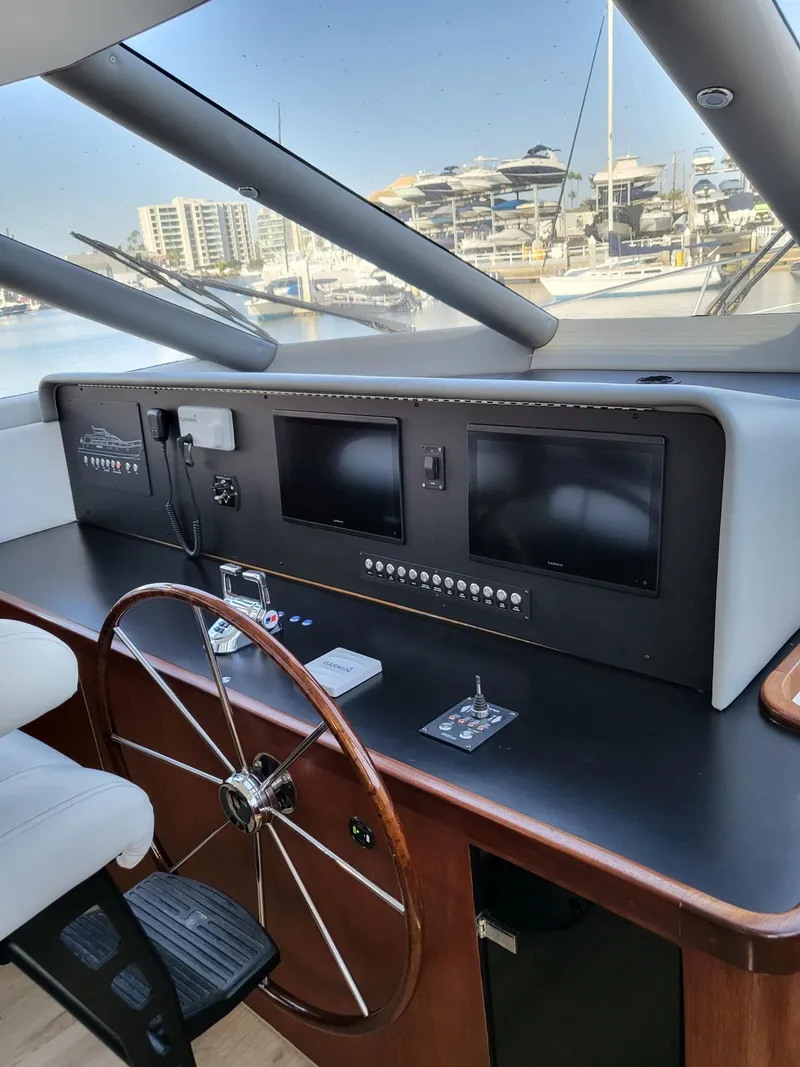 Slide: The Image of 2005 Pacific Mariner 65 SE Motoryacht helm with modern navigation equipment and steering wheel. - 9