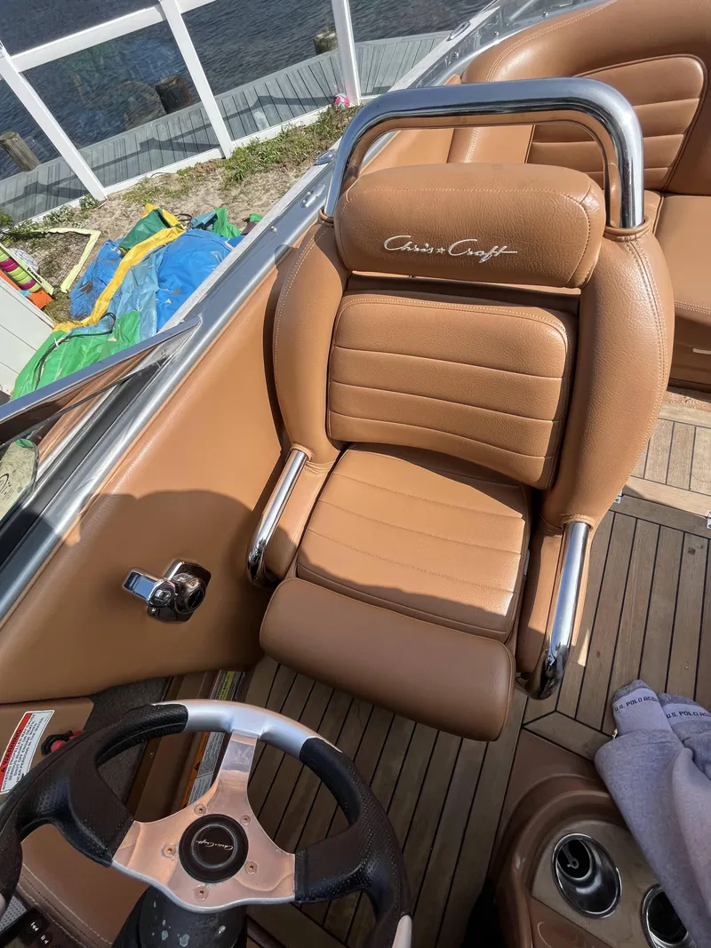 Slide: The Image of 2011 Chris-Craft Silver Bullet 20 boat interior with tan leather seats and steering wheel. - 10