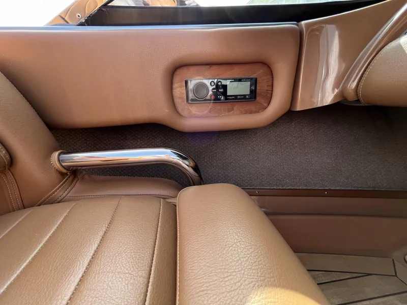 Slide: The Image of 2011 Chris-Craft Silver Bullet 20 interior with tan leather seats and built-in audio system. - 12