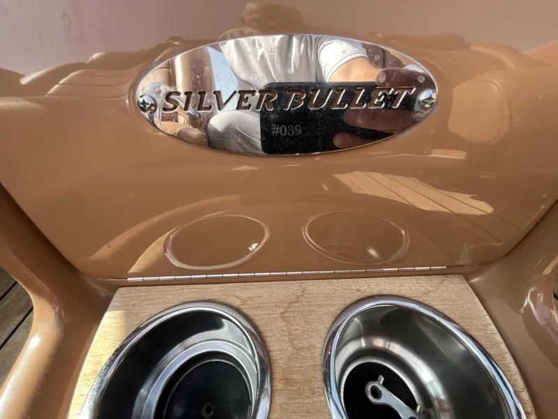Slide: The Image of 2011 Chris-Craft Silver Bullet 20 boat interior with model nameplate and cup holders. - 14