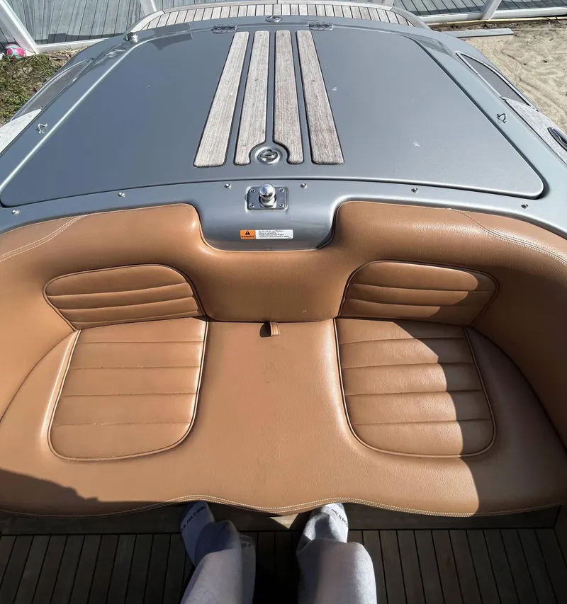 Slide: The Image of 2011 Chris-Craft Silver Bullet 20 boat with tan leather seating and wooden deck. - 16