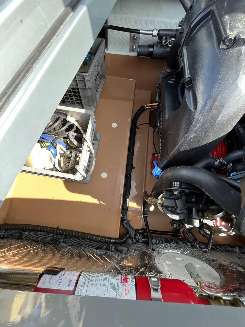 Slide: The Image of 2011 Chris-Craft Silver Bullet 20 engine compartment with wiring and fire extinguisher. - 18