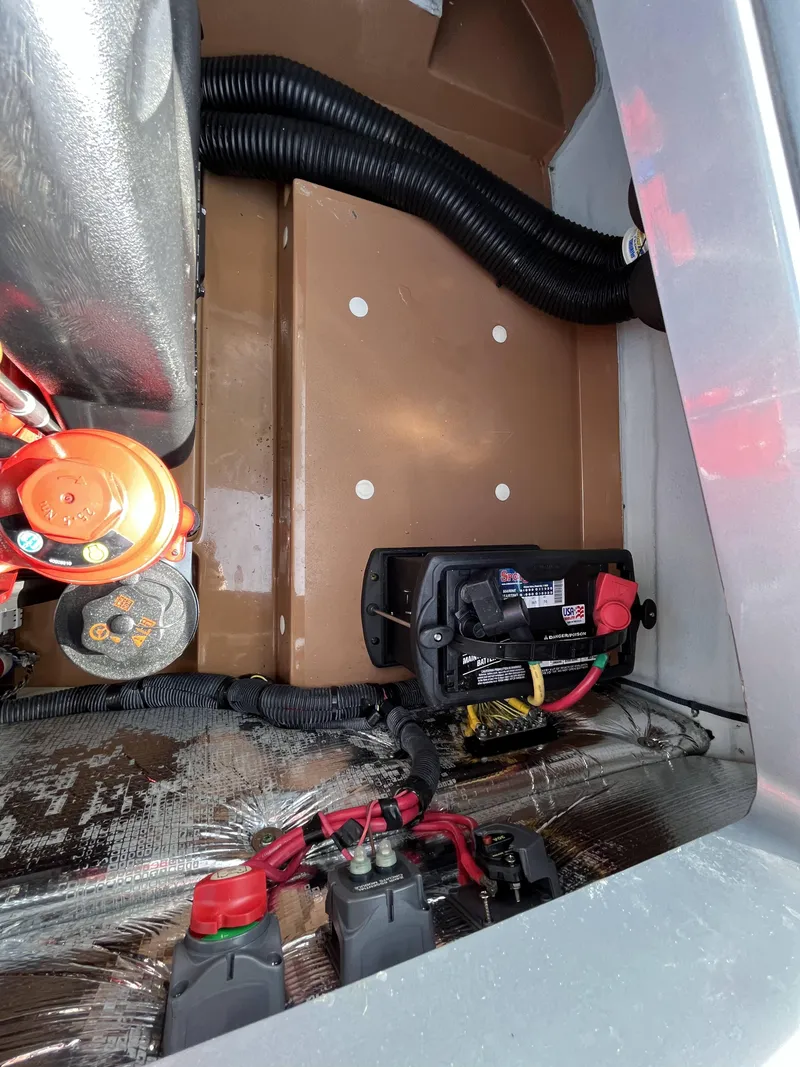 Slide: The Image of 2011 Chris-Craft Silver Bullet 20 engine compartment with battery and wiring. - 20