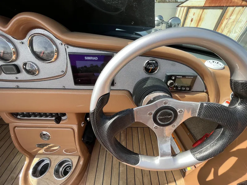 Slide: The Image of 2011 Chris-Craft Silver Bullet 20 dashboard with steering wheel and navigation system. - 9