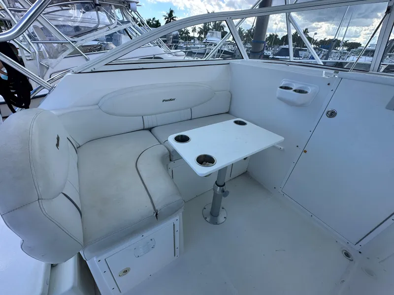 Slide: The Image of 2008 ProKat 3660 Sport Fish boat interior with white seating and table. - 10