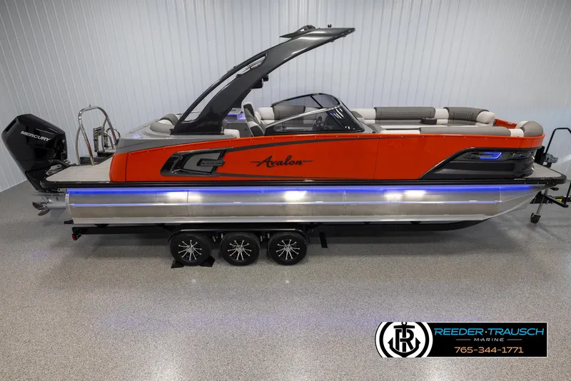 The Image of 2024 Avalon 2785 Excalibur EL pontoon boat in showroom with Reeder-Trausch Marine logo. - 1