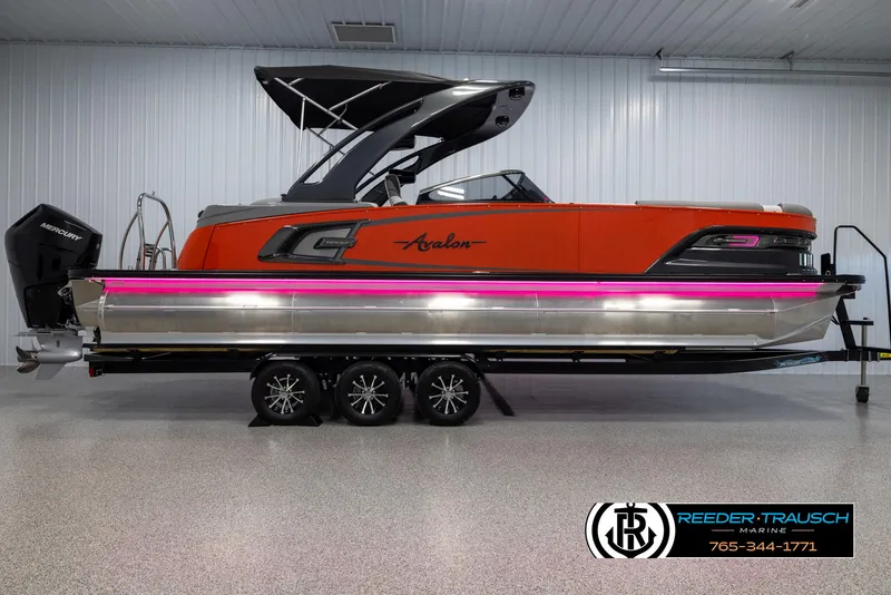 Slide: The Image of 2024 Avalon 2785 Excalibur EL pontoon boat in showroom with trailer. - 10
